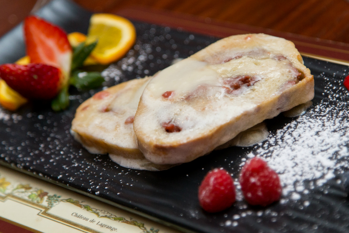 BahamianHolidayRecipes-Cover a slice of cake with fruit on top of a wooden table