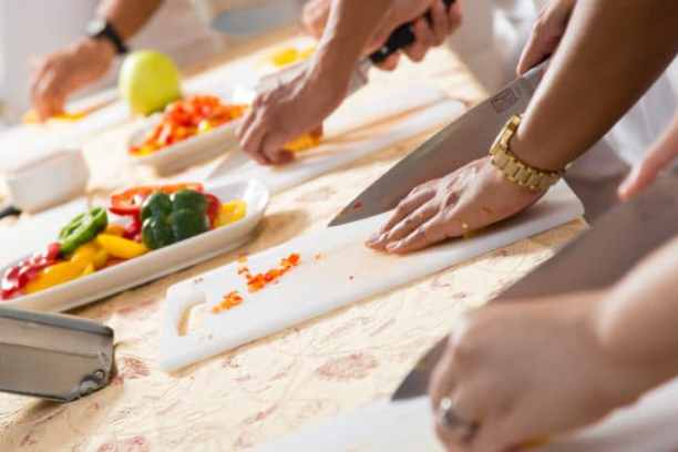 a woman cutting a cake