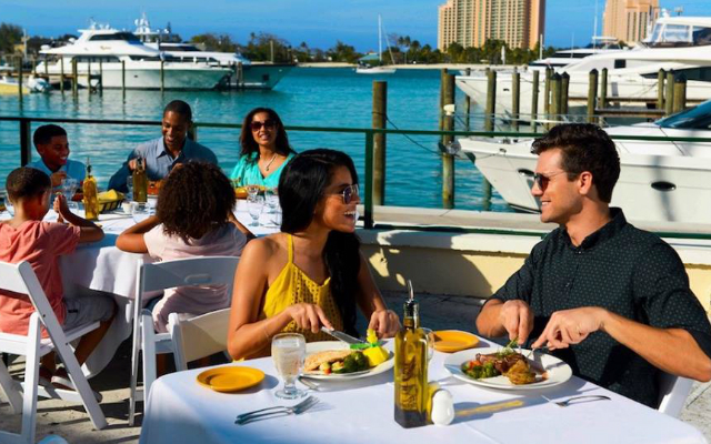 TBFTEast2 a group of people sitting at a table with food and water