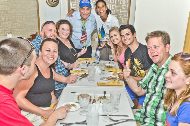 a group of people sitting at a table posing for the camera